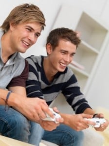 Closeup of two friends playing video game