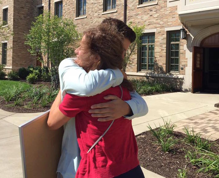 mom and son hugging on move in day