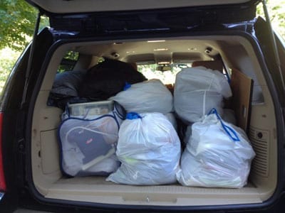 College dorm move in day van loaded with matching luggage