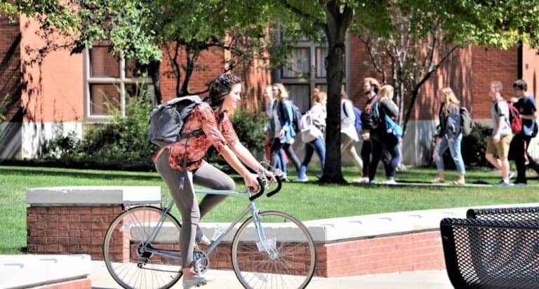 college student riding a bike