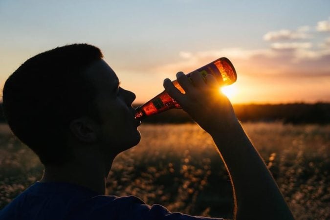 young man drinking alcohol 