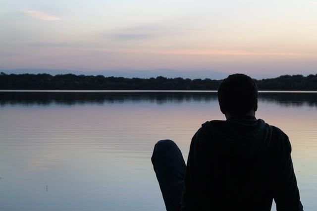 teen boy looking at sunset