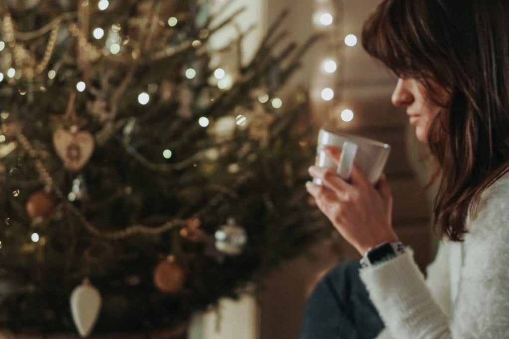 woman in front of Christmas tree 