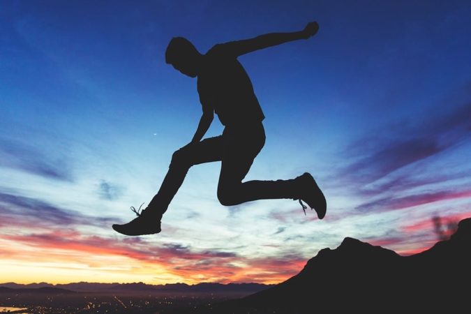 teen jumping in sunset 