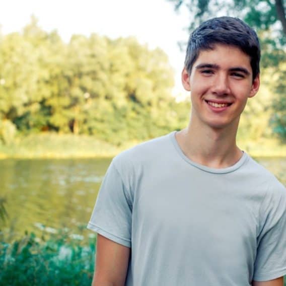 teen boy by a lake