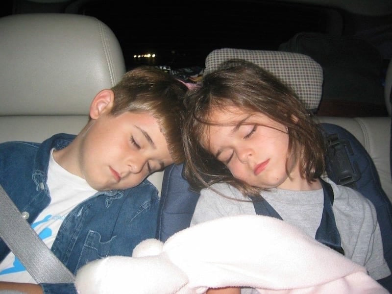 brother and sister asleep in car 