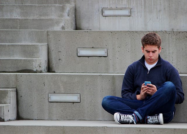 teen boy texting 