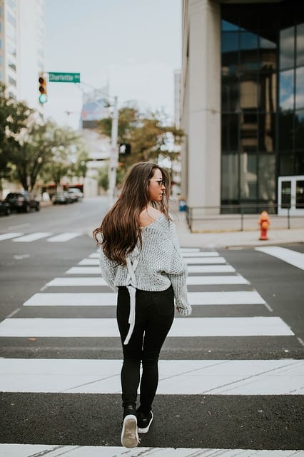 young woman crossing the street 