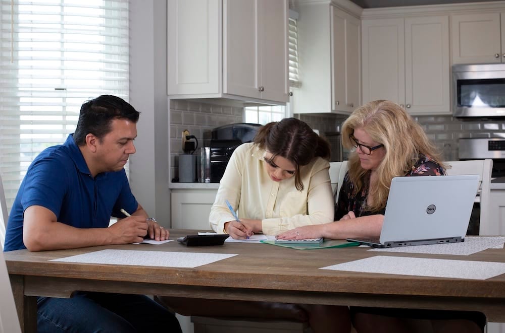 Family looking at information about college admissions and paying for college