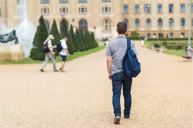 young man walking on campus 