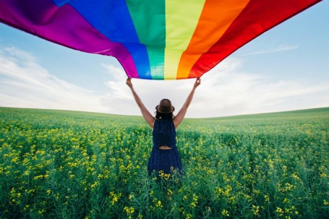 Girl holding rainbow flag
