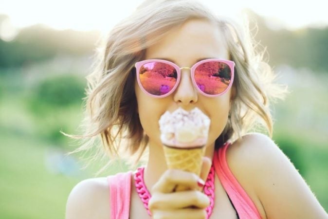 teenage girl eating an ice cream cone