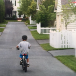 child biking away