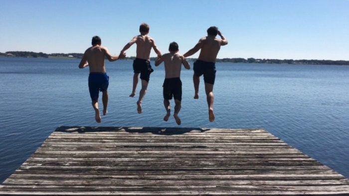 teens jumping into a lake 