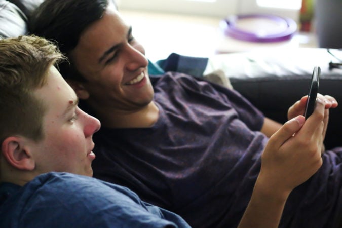 teen boys looking at phone 