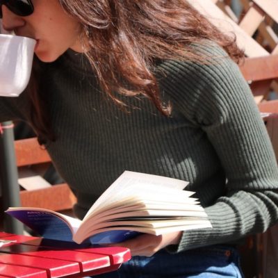 mom reading book and drinking coffee