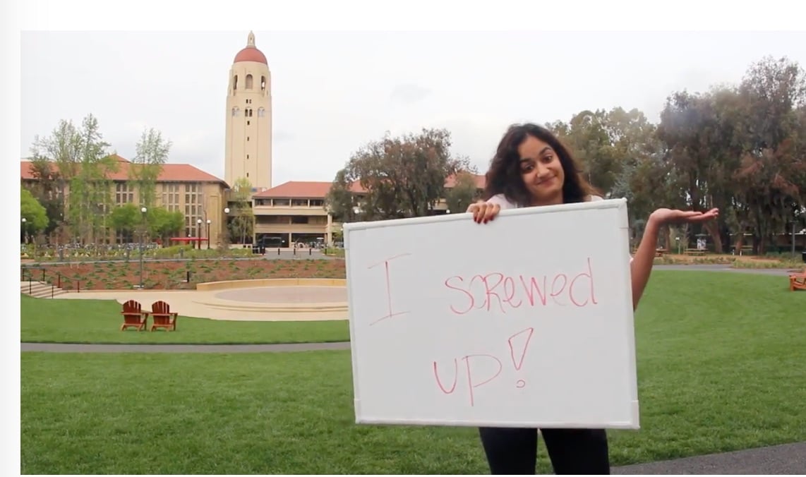 student holding sign at Stanford