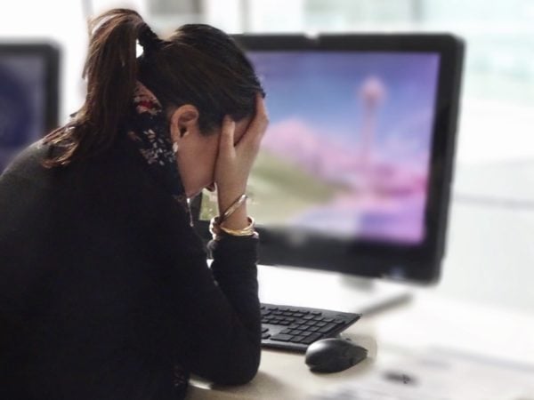 woman at desk upset 