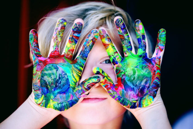 young child finger painting 