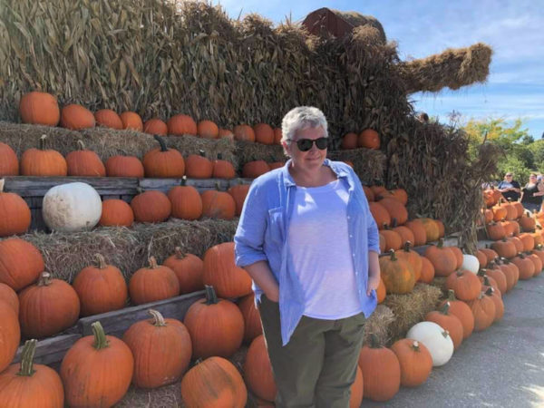 50 year old woman in front of pumpkin