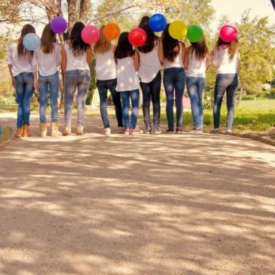 teen girls holding balloons