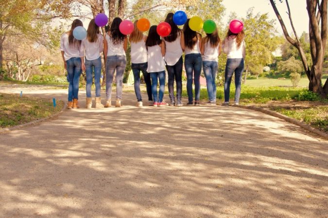 teen girls holding balloons 