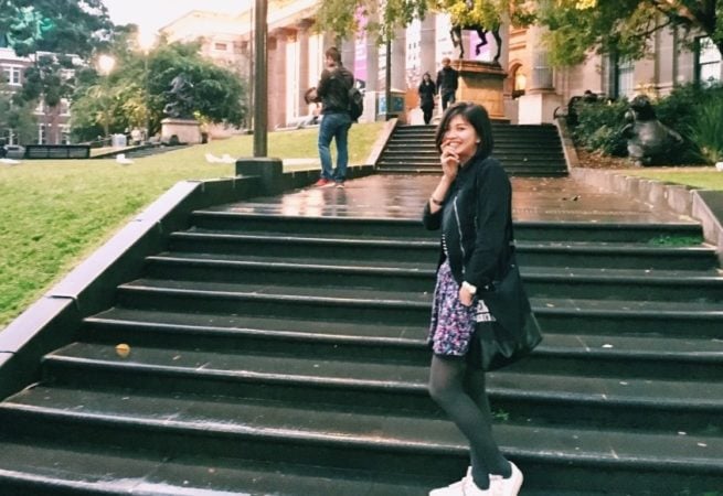 girl standing on college steps 