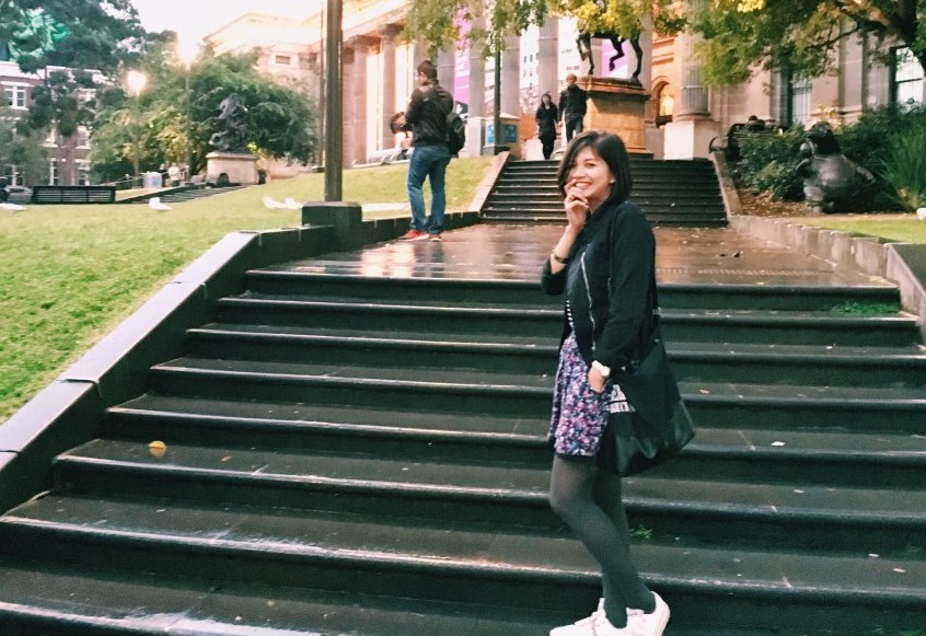 girl standing on college steps