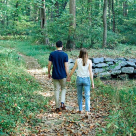 young couple walking in woods