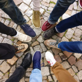 teens putting feet in a circle