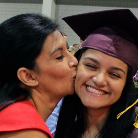 mom kissing daughter