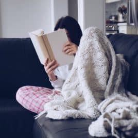teen reading on couch