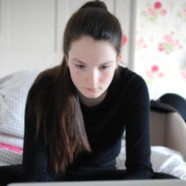 teen studying in her bedroom