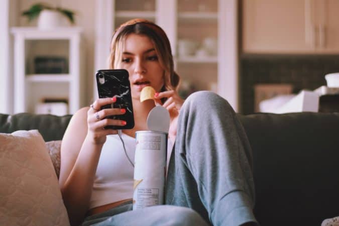 teen girl on couch on phone