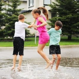 tweens jumping in puddles