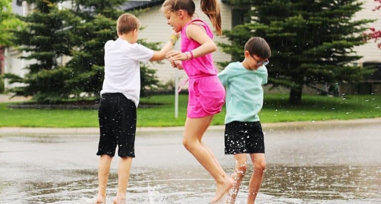 tweens jumping in puddles
