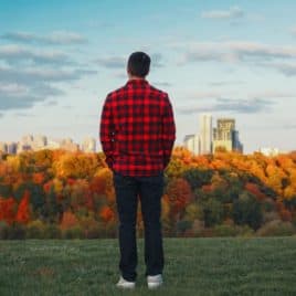 young man standing alone in fall