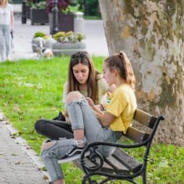 two teens on a bench
