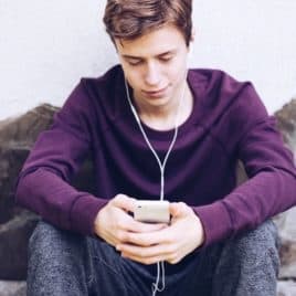 teen boy looking at his phone