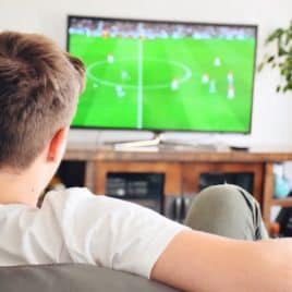 teen boy watching soccer on TV