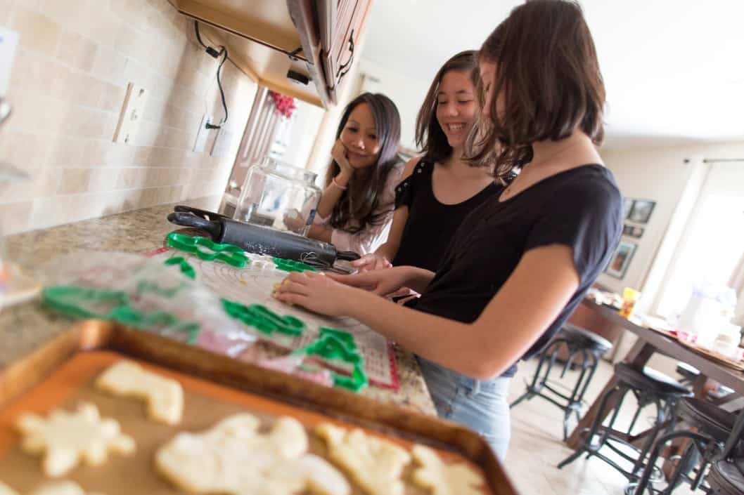 mom and daughters baking Christmas cookies 