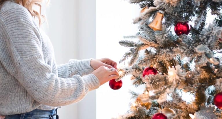 trimming Christmas tree