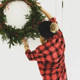 Woman hanging wreath