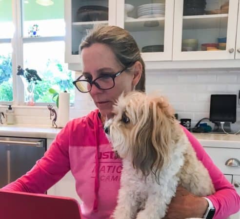 woman with dog in kitchen