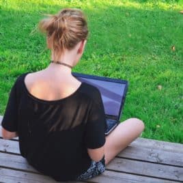 girl on laptop in backyard