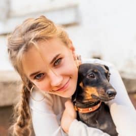 teen girl hugging dog
