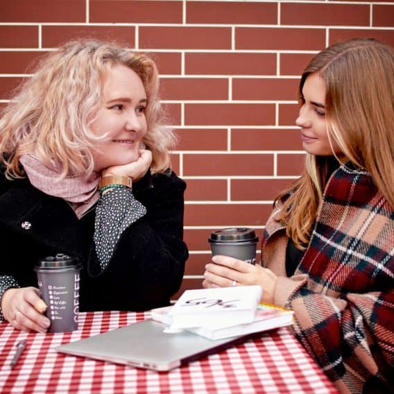 mom and daughter talking at a cafe