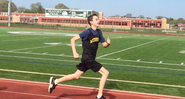 boy running in a track meet