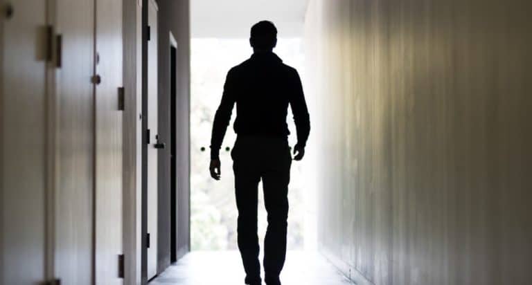 man walking down a hallway