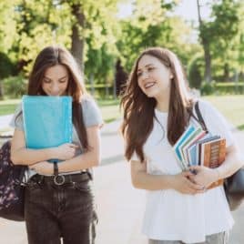 girls walking and carrying books